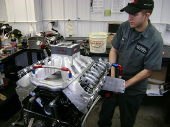 this engine tech is putting the finishing  touches on a 400-plus cubic inch small-block ford. ford small-blocks have more deck height to work with than small-block chevys and a little more room inside of the crankcase.