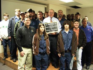ronnie bush, auto technology instructor, (holding award plaque) gathers with his students and ed sunkin, editor of tomorrow’s technician, following an awards presentation by delphi at the tennessee technology center at jackson.