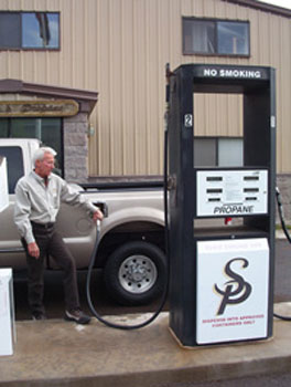photo 2: propane-powered vehicles’ power, acceleration and cruising speed are similar to those of gasoline powered vehicles. shown here, an employee of superior propane fuels his vehicle in williams, az.
