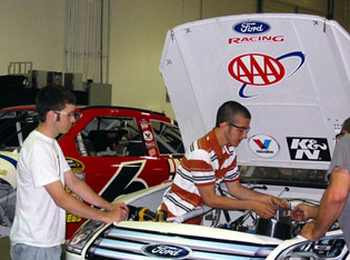 Chris Cheek (left) and Paul Bretl (right) from Grafton, Wis., work on a Roush Fenway Racing race car during their dream learning experience with Roush Fenway Racing in 2008.