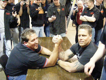rich evans of huntington beach bodyworks and waubonsee community college automotive course instructor ken kunz prepare to do battle – arm wrestling style.
