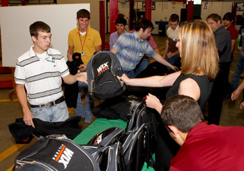 students receive backpacks, ballcaps and shirts from sponsors chicago pneumatic and wix filters.