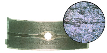 figure 2: babbitt bearing embedded with machining debris. the inset photo shows microscopic detail of the debris.  (courtesy of federal-mogul)