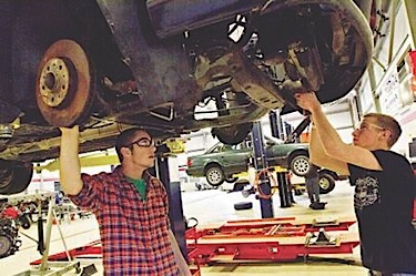 Seacoast School of Technology student Heath Richards of Stratham, left, and Daumanic Fucile of Seabrook perform service on a Volvo at the school.    Photo by Ioanna Raptis www.seacoastonline.com