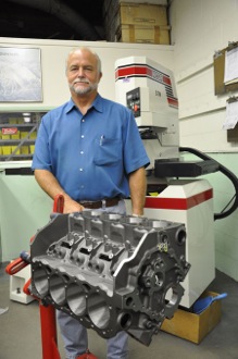 frank honsowetz, general manager of ed pink racing engines, poses with the dart shp block that was the foundation for the small block build.
