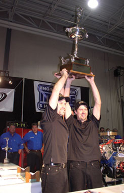 dennis borem and darell hoffman celebrate victory with the randy dorton memorial trophy at the 2008 mahle engine builder showdown.  