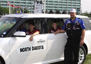 The 2010 Ford/AAA Student Auto Skills National Champions, Jonathan Anderson and McKenzie Nordland, from Sheyenne Valley Area & Technology Center in Valley City, ND, with their instructor James McFagden at the finish line. 